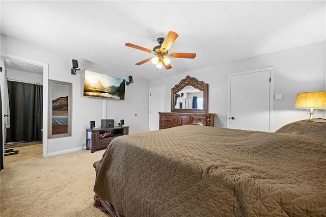 bedroom with light carpet, ceiling fan, and baseboards