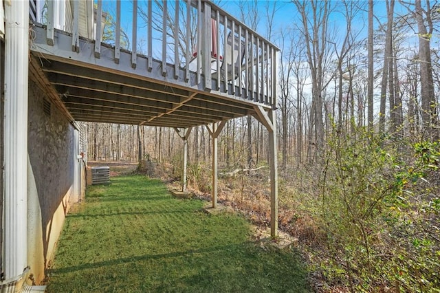 view of yard featuring central air condition unit and a wooden deck