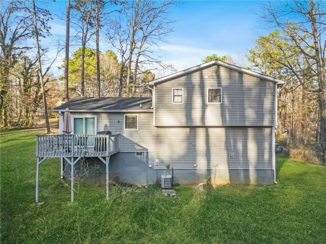 rear view of property featuring a deck, central AC, and a lawn