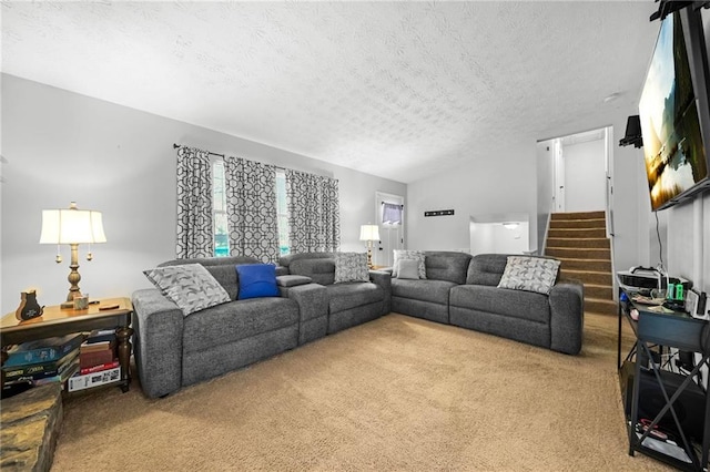 living room featuring carpet, stairs, and a textured ceiling