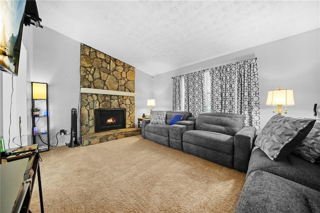 living room featuring carpet flooring, vaulted ceiling, a stone fireplace, and a textured ceiling