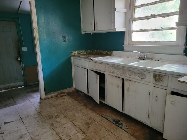 3567 Morgan Dr, Macon, GA 31204 - kitchen featuring white cabinetry and light countertops