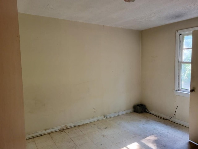 3567 Morgan Dr, Macon, GA 31204 - spare room with a textured ceiling, light flooring, and baseboards
