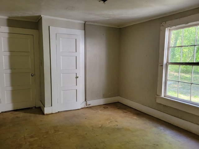 3567 Morgan Dr, Macon, GA 31204 - spare room with ornamental molding, plenty of natural light, tile patterned floors, and baseboards