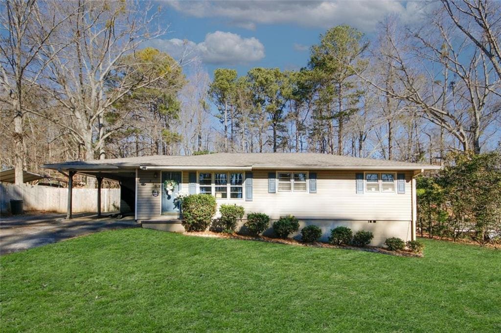 single story home featuring a front yard and a carport