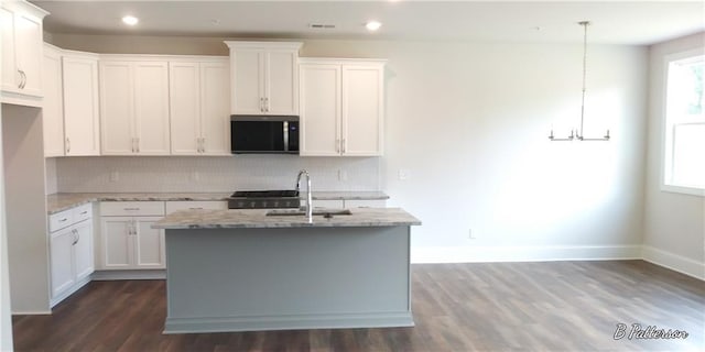 1062 Crest Mill Dr, Marietta, GA 30008 - kitchen with a sink, tasteful backsplash, light stone counters, a chandelier, and dark wood-style flooring