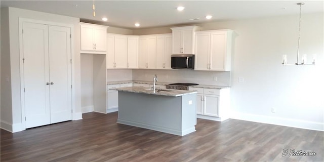 1062 Crest Mill Dr, Marietta, GA 30008 - kitchen with stainless steel microwave, a sink, baseboards, dark wood-style floors, and white cabinetry