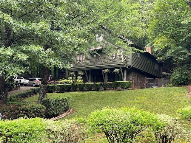 exterior space with a yard and a balcony