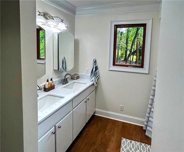 bathroom featuring hardwood / wood-style flooring, crown molding, and vanity