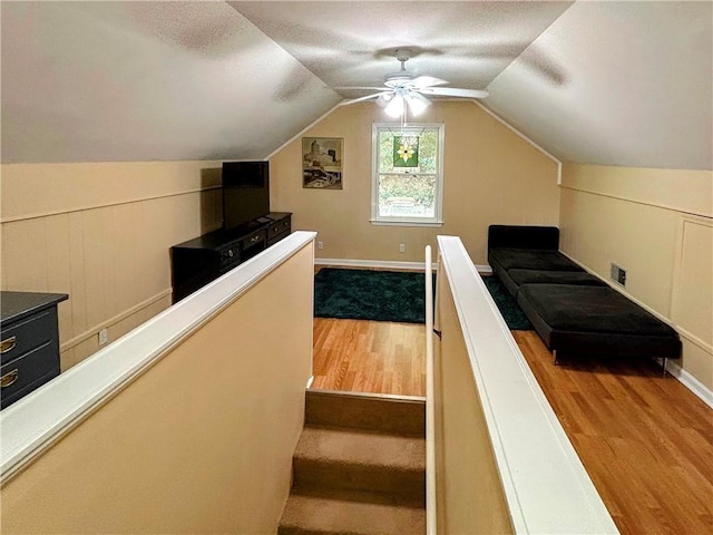 bonus room with vaulted ceiling, light hardwood / wood-style flooring, and ceiling fan