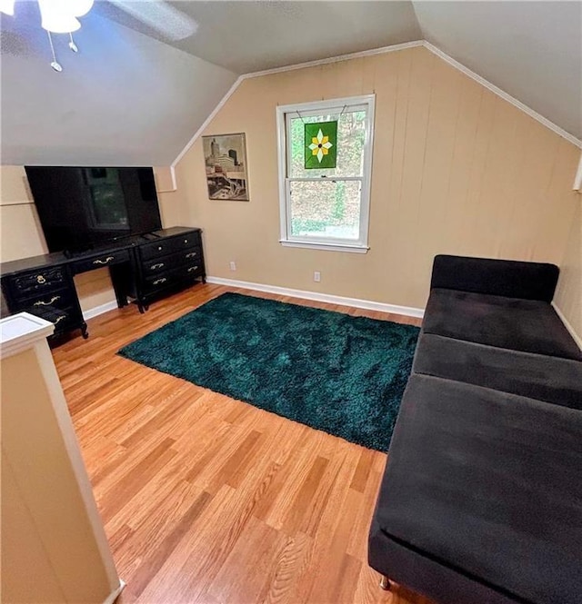 living area featuring vaulted ceiling and hardwood / wood-style flooring