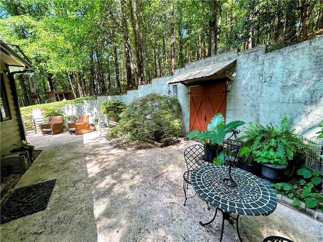 view of patio with a storage unit