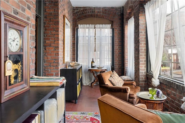 sitting room featuring brick wall