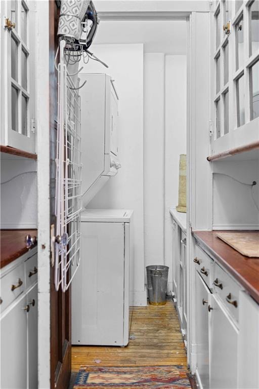 clothes washing area featuring laundry area and dark wood finished floors