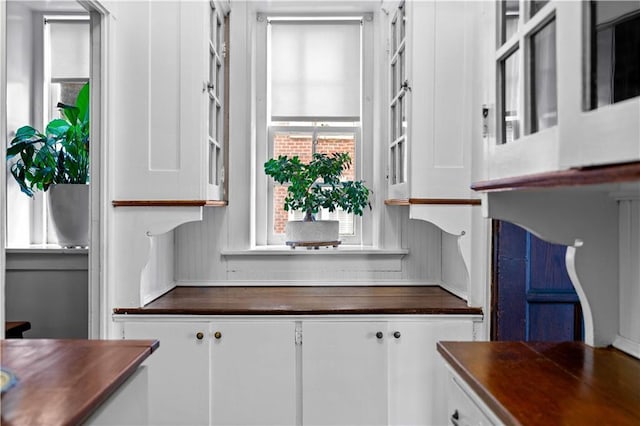 kitchen featuring dark countertops and white cabinetry