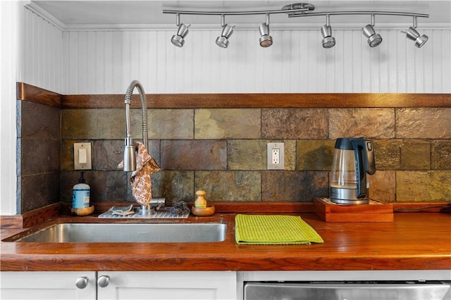 room details featuring dishwasher, backsplash, and a sink