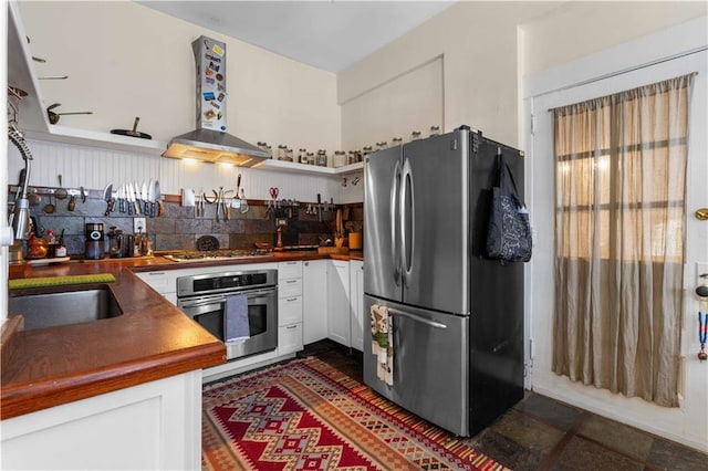 kitchen featuring appliances with stainless steel finishes, dark countertops, and white cabinetry