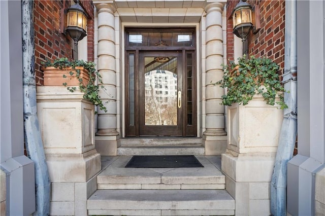 view of exterior entry with brick siding