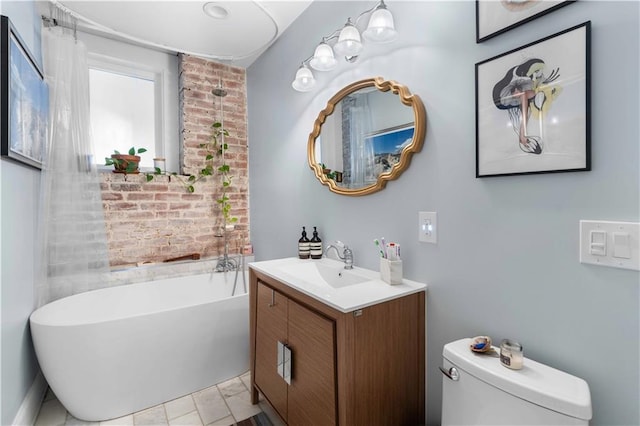 bathroom featuring toilet, a bath, and vanity