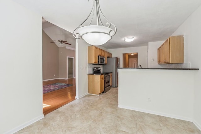 2410 Napa Valley Dr, Villa Rica, GA 30180 - kitchen featuring stainless steel appliances, dark countertops, a ceiling fan, light tile patterned flooring, and brown cabinetry