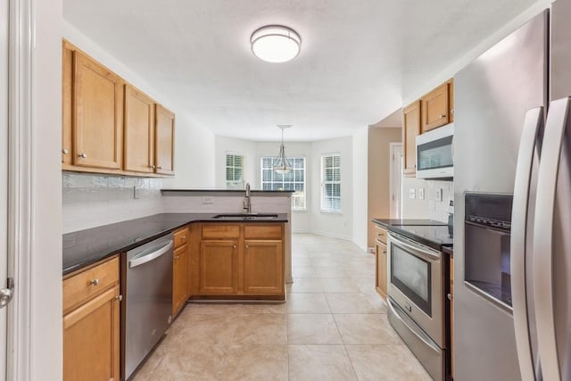2410 Napa Valley Dr, Villa Rica, GA 30180 - kitchen featuring appliances with stainless steel finishes, a peninsula, tasteful backsplash, light tile patterned floors, and pendant lighting