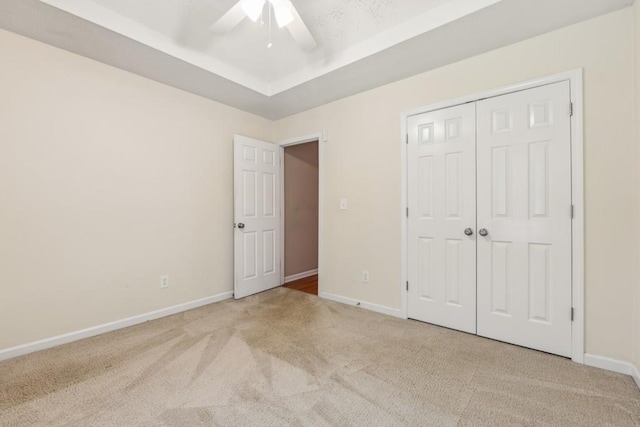 2410 Napa Valley Dr, Villa Rica, GA 30180 - unfurnished bedroom with carpet, a raised ceiling, a closet, and ceiling fan