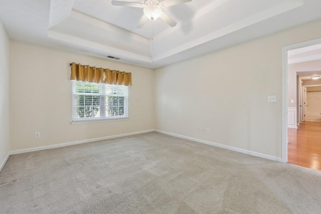 2410 Napa Valley Dr, Villa Rica, GA 30180 - empty room featuring a tray ceiling, carpet flooring, and ceiling fan