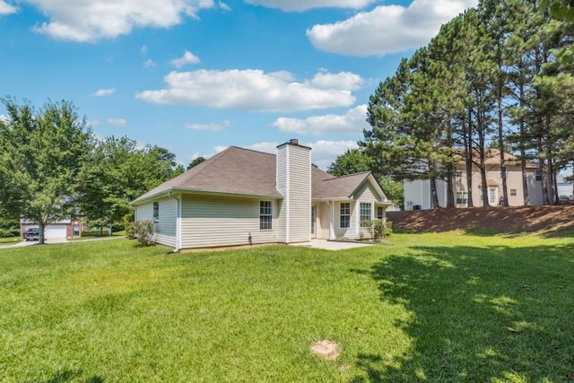 2410 Napa Valley Dr, Villa Rica, GA 30180 - back of property featuring a chimney, a lawn, and roof with shingles