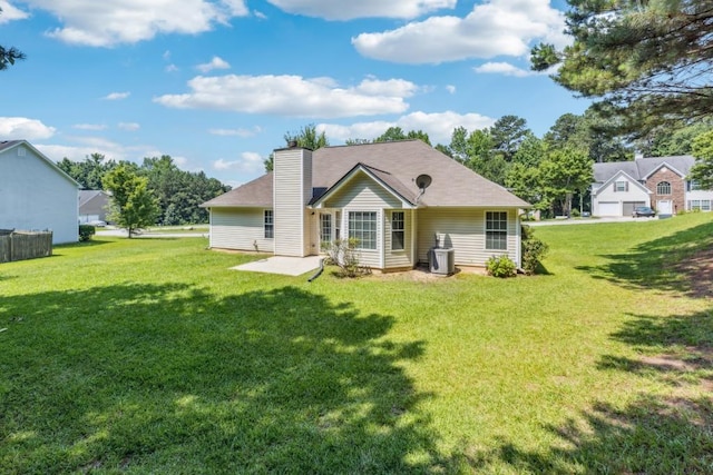 2410 Napa Valley Dr, Villa Rica, GA 30180 - back of house featuring a lawn, a chimney, and a patio