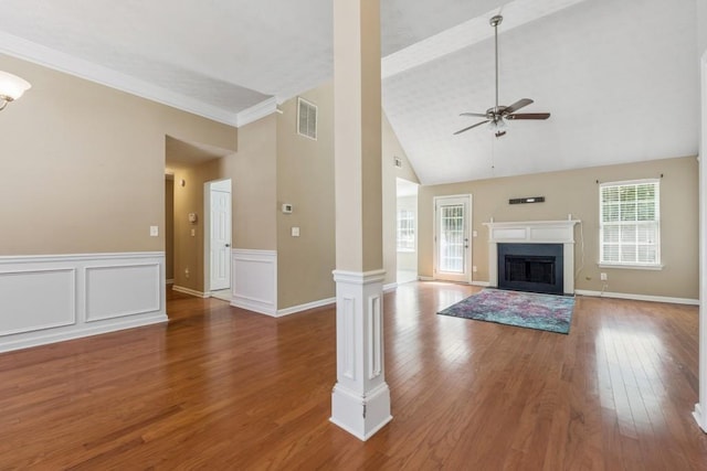 2410 Napa Valley Dr, Villa Rica, GA 30180 - unfurnished living room featuring a ceiling fan, wood finished floors, a fireplace with flush hearth, high vaulted ceiling, and ornate columns