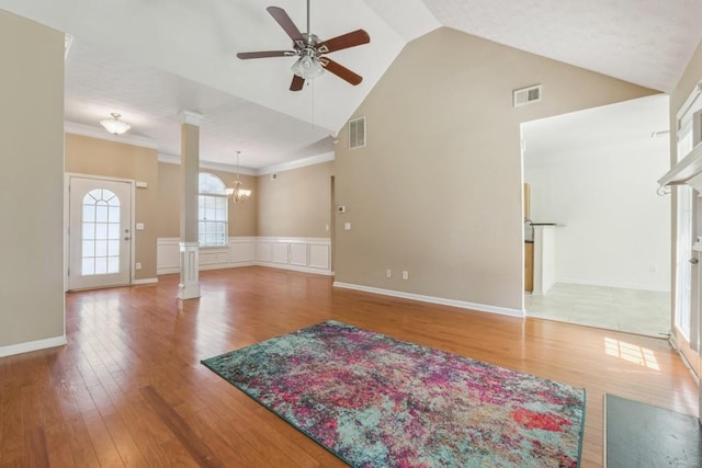 2410 Napa Valley Dr, Villa Rica, GA 30180 - unfurnished living room featuring ceiling fan, wood finished floors, high vaulted ceiling, and a chandelier