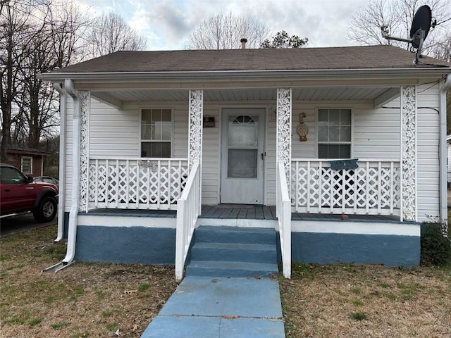 view of front of home featuring covered porch and roof with shingles