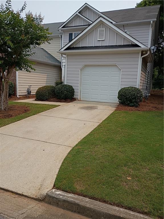 4521 Yellow Sash Ct, Oakwood, GA 30566 - view of front of property featuring board and batten siding, driveway, and a front yard