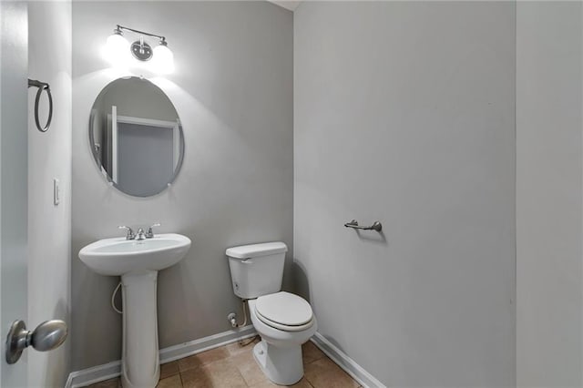 bathroom with sink, tile patterned flooring, and toilet