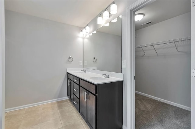 bathroom featuring tile patterned flooring and vanity