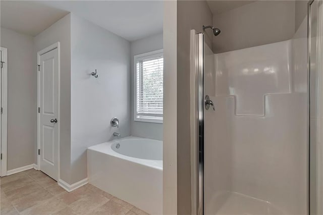 bathroom featuring tile patterned floors and shower with separate bathtub