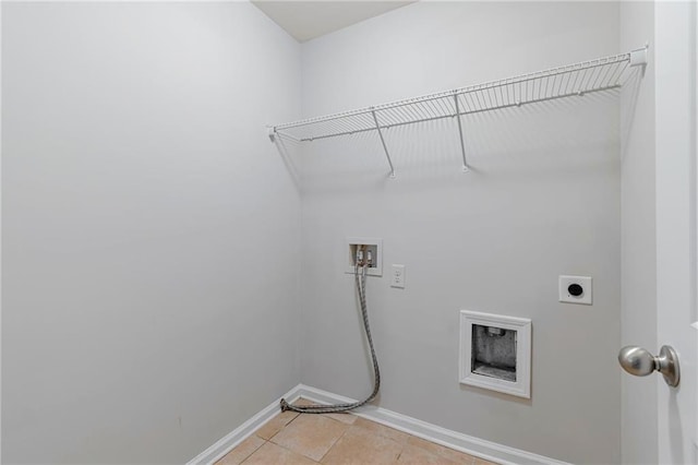 washroom with hookup for an electric dryer, washer hookup, and light tile patterned flooring