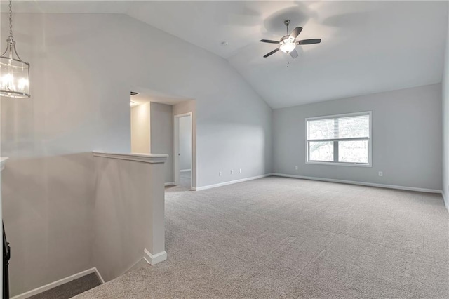 carpeted empty room featuring ceiling fan and lofted ceiling