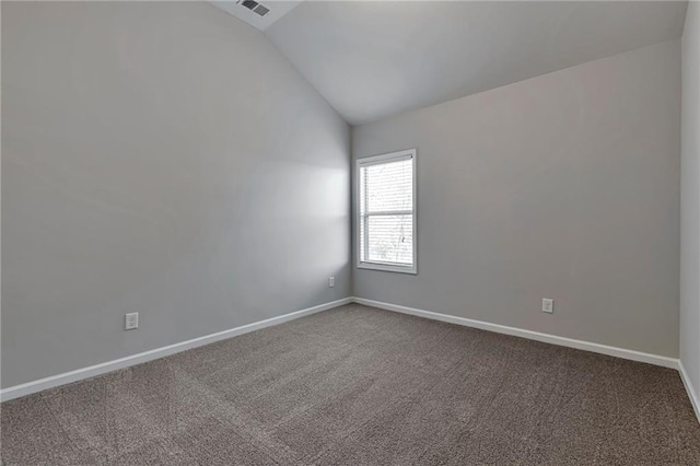 carpeted spare room with lofted ceiling