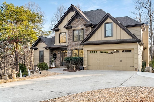 craftsman-style house with stone siding, board and batten siding, concrete driveway, and roof with shingles