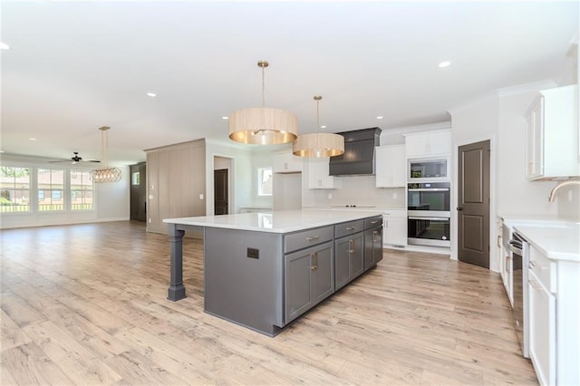 kitchen featuring light countertops, stainless steel appliances, white cabinets, and gray cabinets