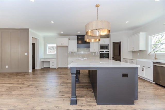 kitchen with decorative backsplash, white cabinetry, a kitchen island, and stainless steel appliances