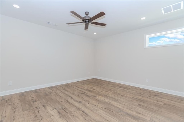 unfurnished room with baseboards, ceiling fan, light wood-type flooring, and visible vents