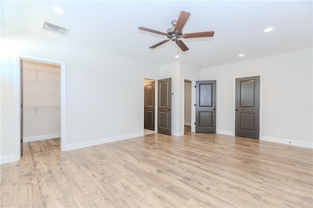 interior space with recessed lighting, a ceiling fan, visible vents, and light wood finished floors