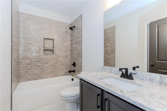 bathroom featuring vanity, washtub / shower combination, and toilet