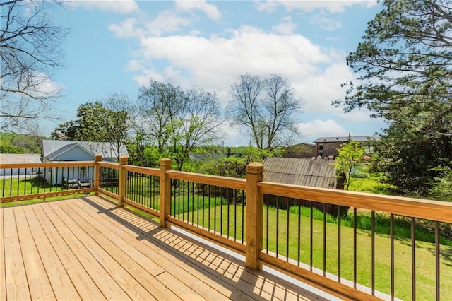 wooden deck featuring a yard