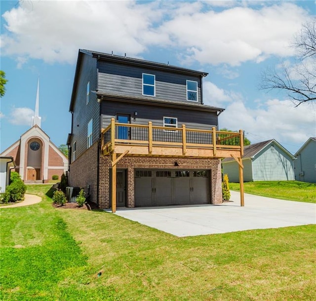 view of front facade with an attached garage, concrete driveway, a front yard, and brick siding