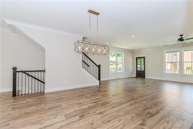 unfurnished living room with ornamental molding, wood finished floors, baseboards, ceiling fan, and recessed lighting