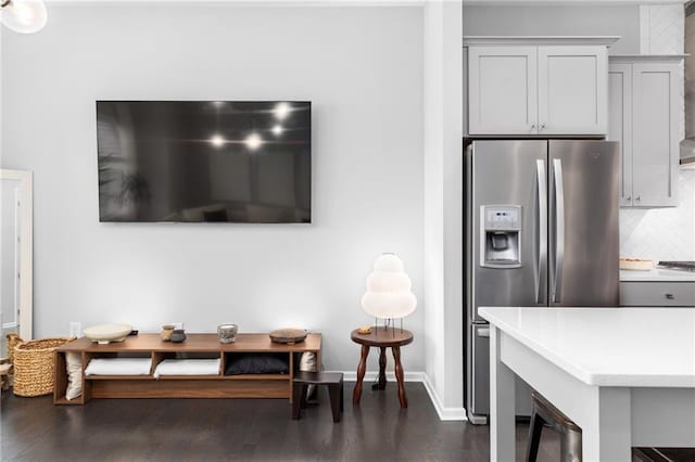 kitchen with decorative backsplash, stainless steel fridge with ice dispenser, dark hardwood / wood-style floors, and gray cabinetry