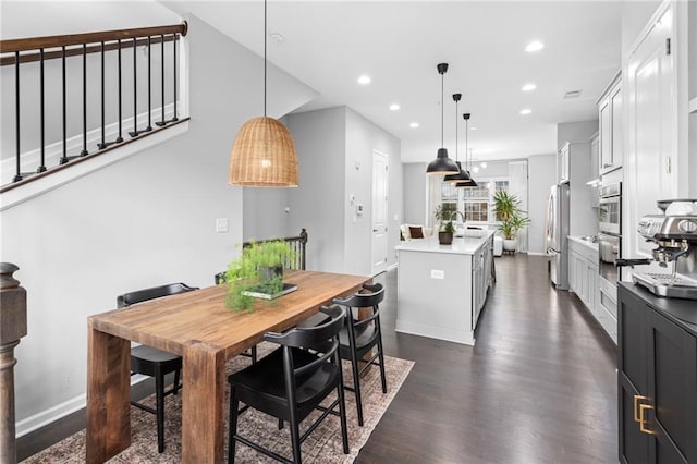 dining space with sink and dark hardwood / wood-style floors